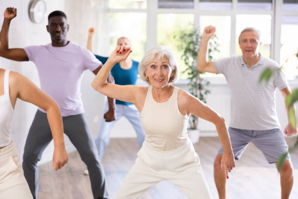 istock Mature men and women practicing Hip-hop dance in training hall 1499661674