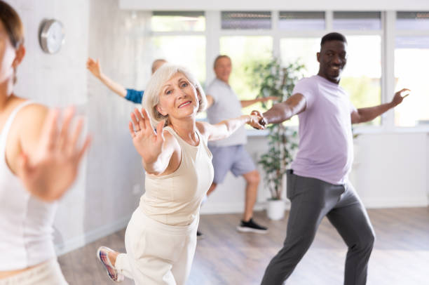 istock Mature men and women practicing Rock 'n' Roll dance in training hall 1499661700