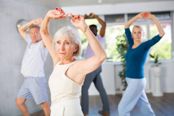 istock Elderly woman practicing flamenco dance moves during group class 1499662068