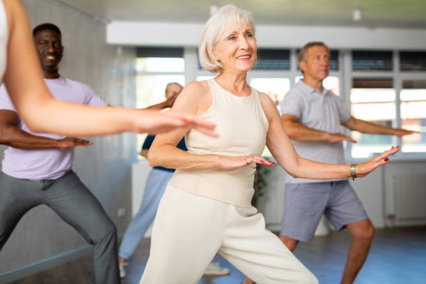 istock Elderly woman dancing hip hop during group dance class 1499662080