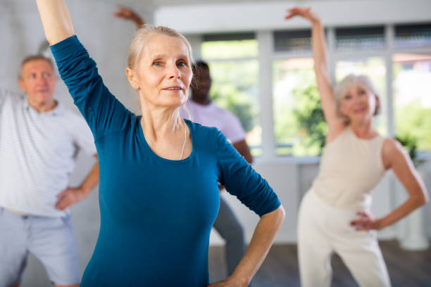 istock Mature men and women practicing Rock 'n' Roll dance in training hall 1499662092