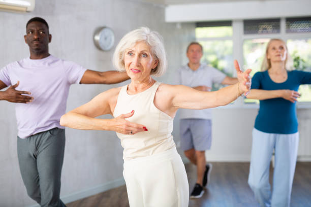 istock Mature men and women practicing Ballroom dances in training room 1499662412