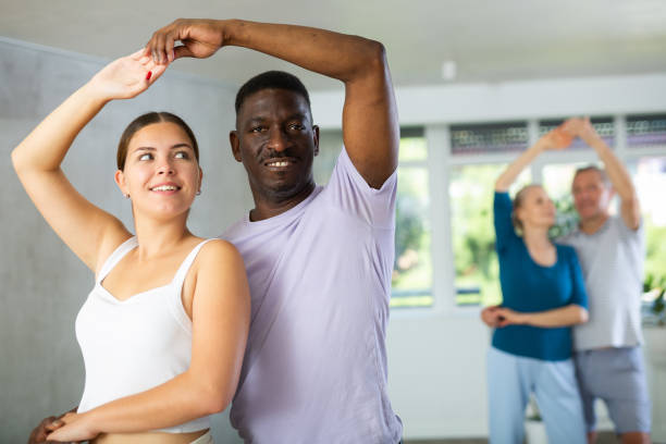 istock Men and women of different ages practicing Ballroom dances in training room 1499662433