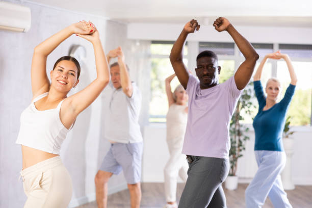 istock Young woman teaching group of multiethnic mature people classical dance 1499662699