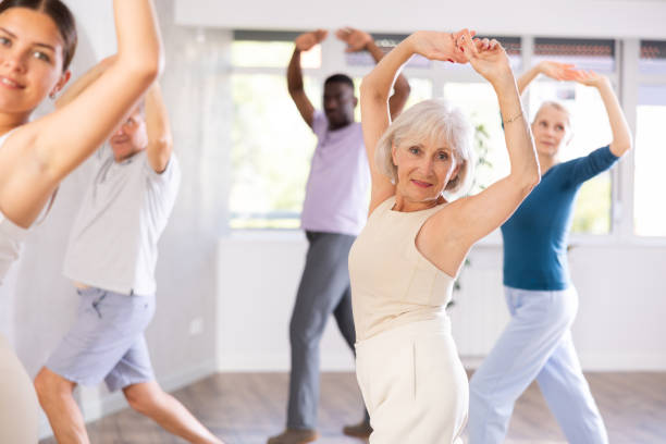 istock Female instructor teaches senior students of different ages basic movements of contemporary dances 1499662700