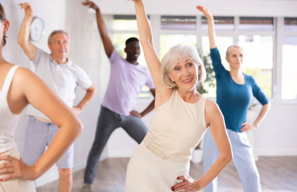 istock Mature men and women practicing Rock 'n' Roll dance in training hall 1499662706