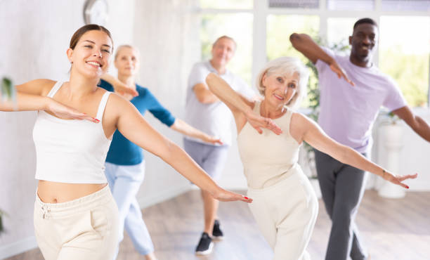 istock Men and women of different ages practicing Hip-hop dance in training hall 1499662714