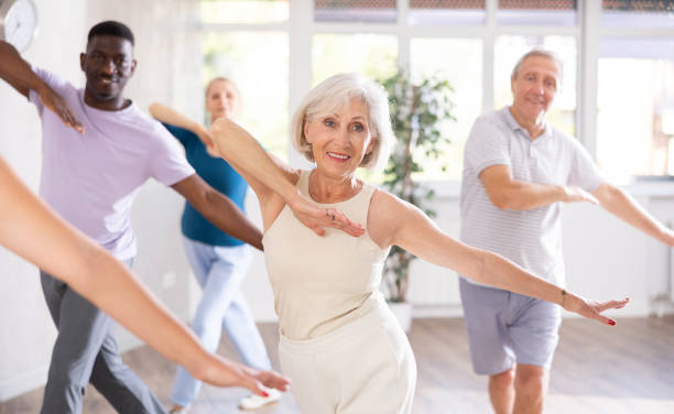 istock Mature men and women practicing Hip-hop dance in training hall 1499662721