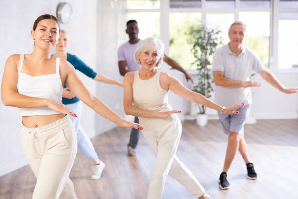 istock Female instructor teaches mature students of dance class basic movements of hip hop dance 1499662733