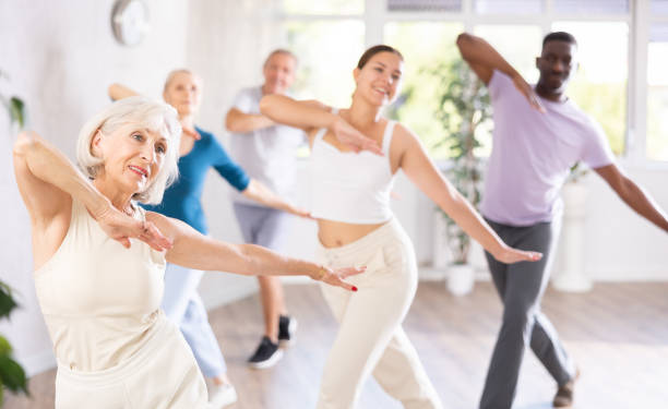 istock Elderly woman enjoying active dance with mixed age group 1499662735