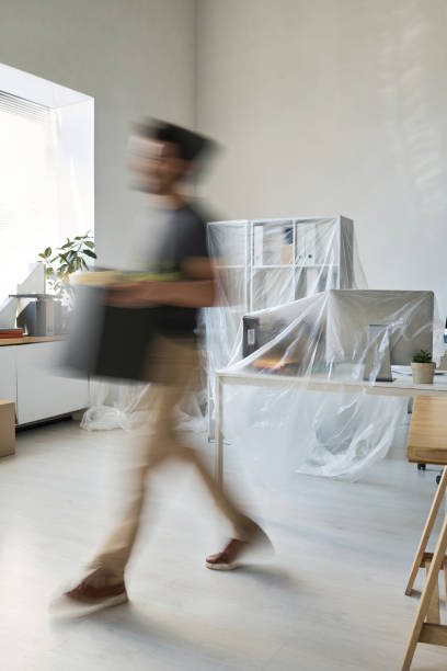 istock Man carrying things in box during the move 1499664139
