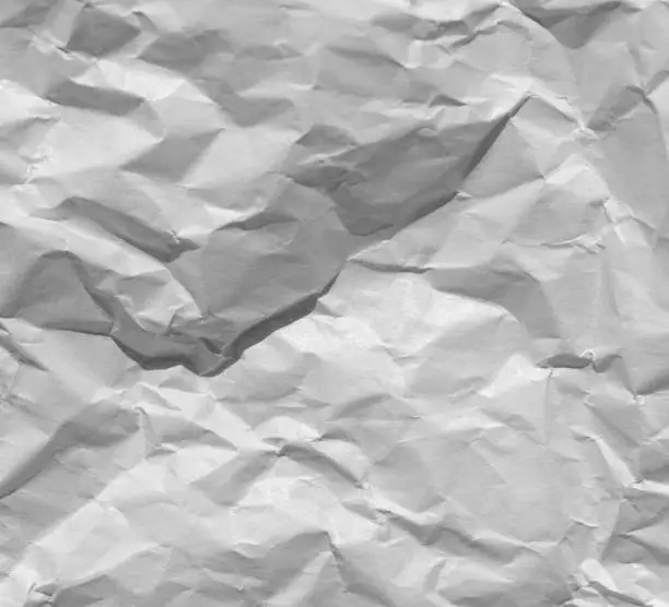 Photo of White wrinkle paper texture background. Crumpled Note Paper. Screwed up piece of paper.