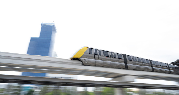 Elevated monorail train fast move on rail. Public transit monorail. Modern mass transit. Rail transportation. Driverless straddle monorail. Monorail technology. Rapid transit in city. Urban transport.