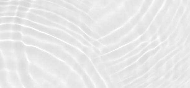 istock White water with ripples on the surface. Defocus blurred transparent white colored clear calm water surface texture with splashes and bubbles. Water waves with shining pattern texture background. 1499666606