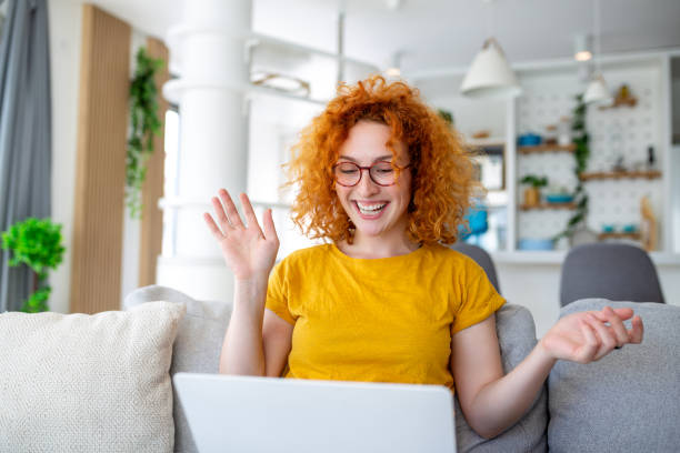 istock Woman sitting with computer on sofa, studying at home, e-learning and remote freelance job concept 1499666620