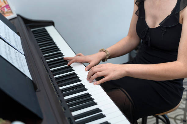 istock Elegant Young Pianist Masterfully Plays the Black Keys 1499668218