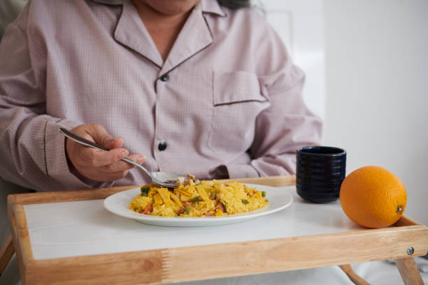 istock Senior Woman Eating Lunch in Bed 1499668846