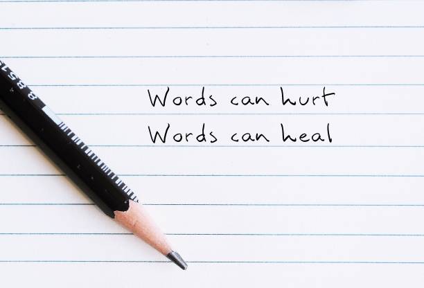 istock Pencil on paper note with handwritten text Words can hurt Words can heal - to remind language have power to harm or heal - word choice matters most so choose wisely 1499669575