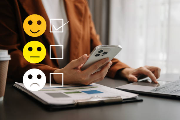 istock Customer service evaluation concept. woman Show face smile emoticon show on virtual screen from hand.looking at smart phone, tablet and laptop in office 1499669633