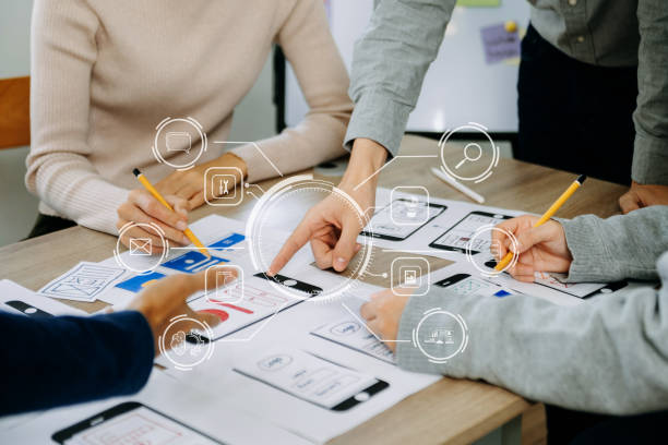 istock Close up view of UI developer team brainstorming on their project with laptop, smartphone and digital tablet. Creative digital development agency. with VR icon 1499669710