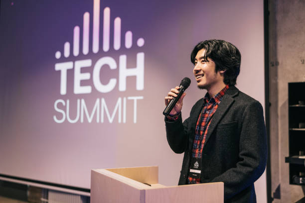 istock Japanese Businessman speaking with audience on Tech conference. 1499669953