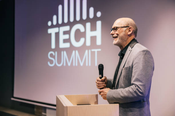 istock Senior businessman speaking with audience on Tech conference. 1499669954