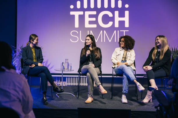 istock Group of multi-ethnic businesswoman making a great panel discussion on stage. 1499670322