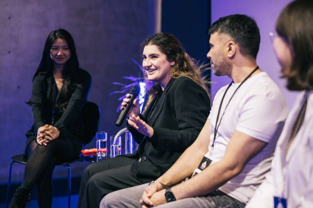 A group of multi ethnic entrepreneurs, making a great panel discussion on stage. stock photo