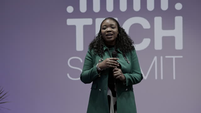 African Businesswoman speaking with audience on Tech conference.