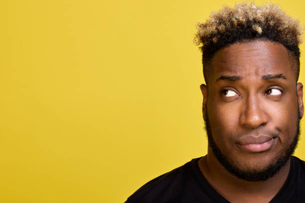 istock Dark-skinned man with beard with smirk on his face looks to side in disapproval 1499672015