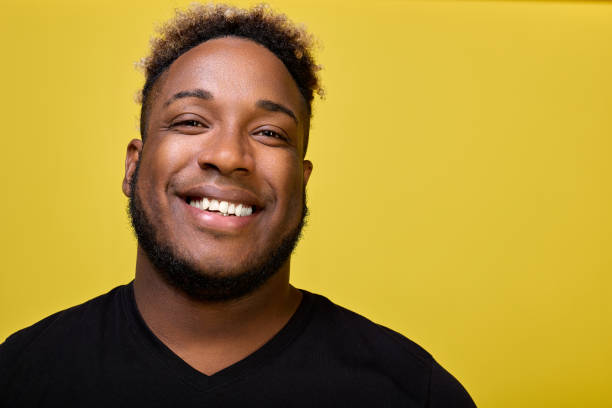 istock Curly-haired African American shines with snow-white smile. 1499672267