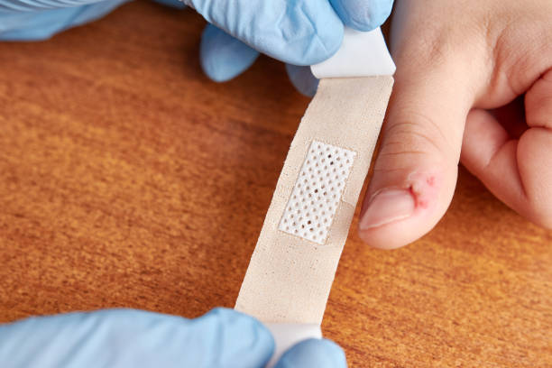 istock A patch is stuck on the child's scratched finger. Decontamination and first aid for minor scratches. 1499672817