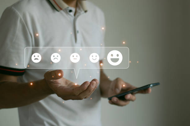 istock Man using smartphone choosing happy smiley face icon to give service satisfaction Very impressive scores over the wireless network. 1499673142