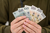 Polish cash banknotes PLN 800 held in male hands in the form of a fan