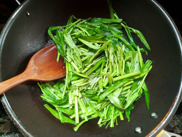 istock Cooking Stir fried Morning Glory vegetable - food preparation. 1499673745