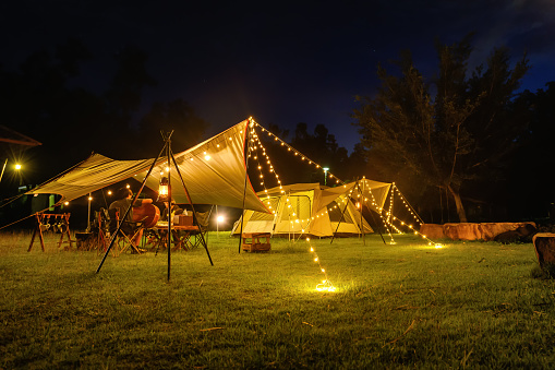 https://media.istockphoto.com/id/1499674223/photo/outdoor-camping-tent-with-tarp-or-flysheet-on-grass-courtyard-and-warm-night-light-under-dark.jpg?s=170667a&w=0&k=20&c=9Ttb-ItlctdWoKPeMi3lJvga6AKpNn4Z2nLnUp0k4R4=