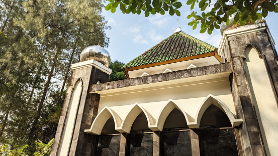 Mosque with trees and blue sky in the background at Yogyakarta, indonesia