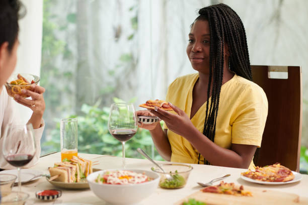 istock Woman Eating at Dinner Party 1499675546