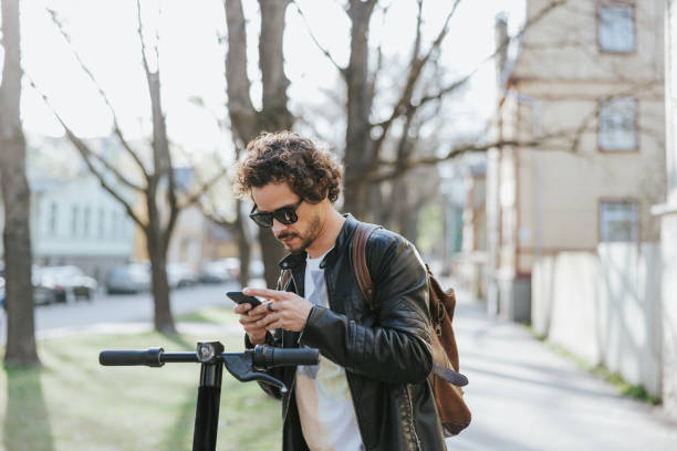 istock Businessman unlocking mobility E-scooter with smartphone 1499677345