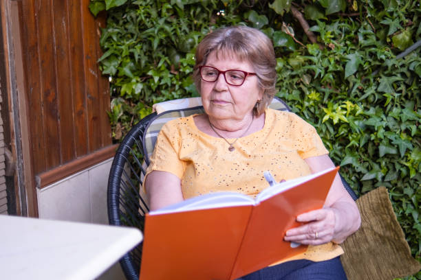 istock Senior woman writing down her findings about VR 1499678361
