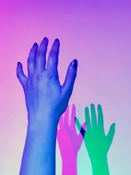 istock two shadows green and pink from a woman's hand illuminated with blue light 1499679369