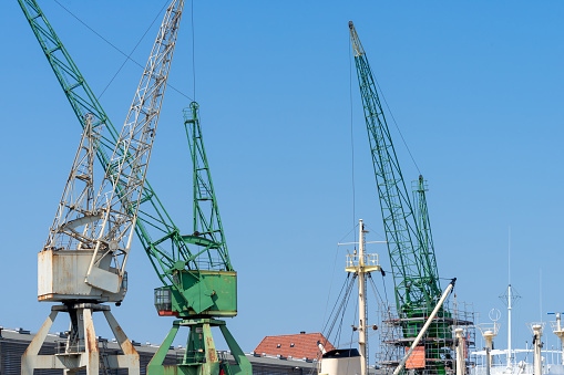 Low angle view of crane at Hamburg harbor against clear sky, Hamburg harbor