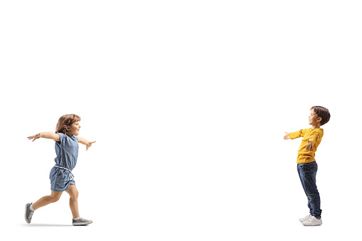 Little girl running to hug a boy isolated on white background