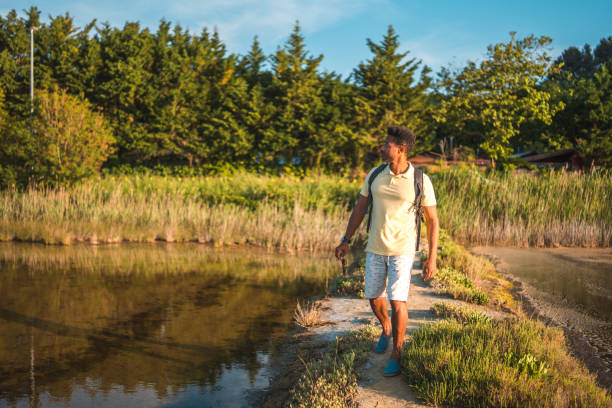 istock A Content Mid Adult Hispanic Man Strolling Through the Marshland 1499680762