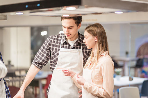 Young couple passionately engaged in the art of culinary creation