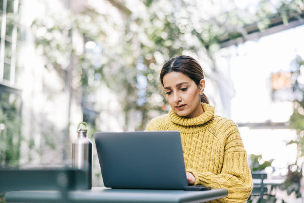 istock Female freelancer working from cozy street cafe 1499682922