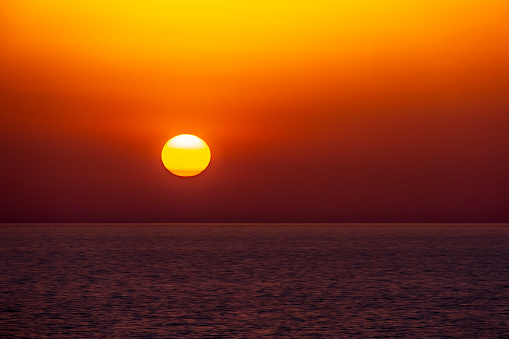 A beautiful sunset over the horizon at sea.