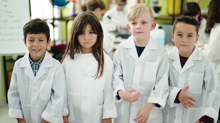 Group of kids scientists students smiling confident standing with arms crossed gesture at laboratory classroom