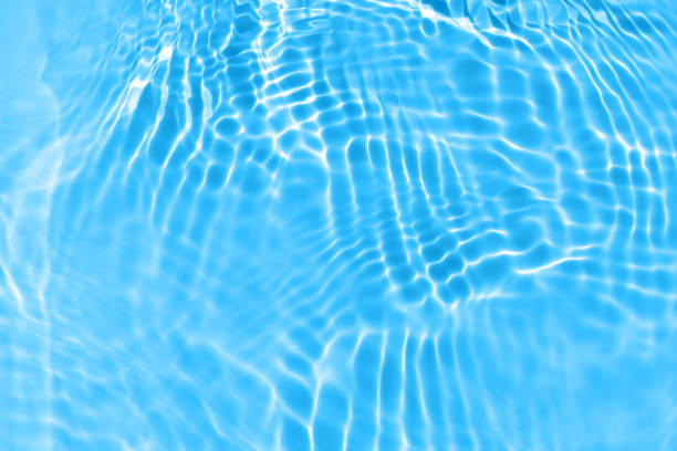 istock Blue water with ripples on the surface. Defocus blurred transparent blue colored clear calm water surface texture with splashes and bubbles. Water waves with shining pattern texture background. 1499684002