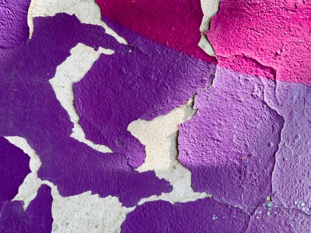 istock Vibrant purple wall with peeled-off paint. 1499686655